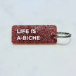 LIFE IS A BICHE Porte-clés à paillettes Plus de Love