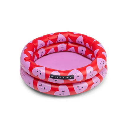 Piscine bébé coeur rose fond rouge